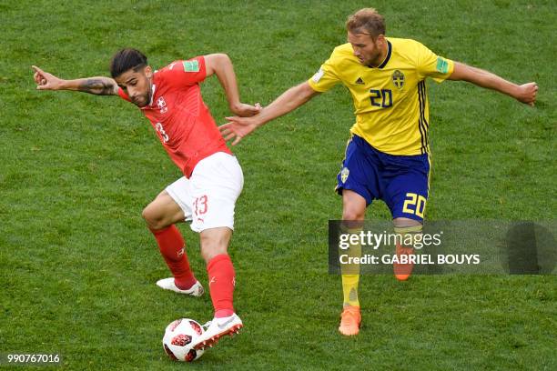 Switzerland's defender Ricardo Rodriguez vies with Sweden's forward Ola Toivonen during the Russia 2018 World Cup round of 16 football match between...
