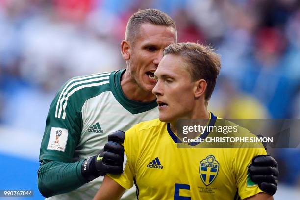 Sweden's goalkeeper Robin Olsen speaks to Sweden's defender Ludwig Augustinsson during the Russia 2018 World Cup round of 16 football match between...
