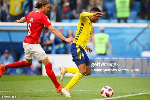 Michael Lang of Switzerland fouls Martin Olsson of Sweden and is subsequently sent off during the 2018 FIFA World Cup Russia Round of 16 match...