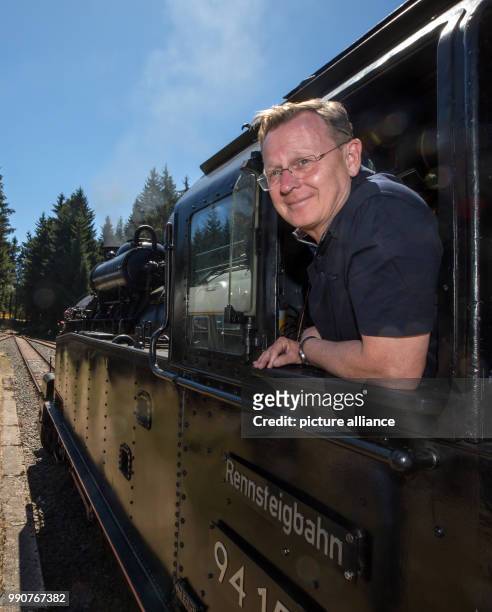 July 2018, Germany, Schmiedefeld: Thuringia Premier Bodo Ramelow riding into Rennsteig Station in the cab of freight train tank engine 941538 of the...