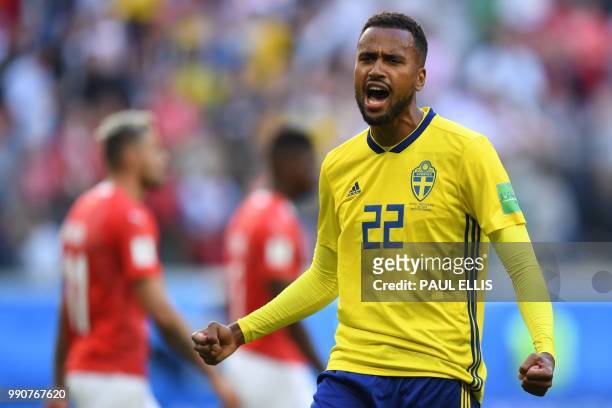 Sweden's forward Isaac Kiese Thelin celebrates their victory at the end of the Russia 2018 World Cup round of 16 football match between Sweden and...