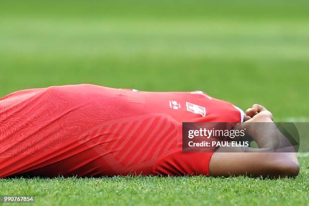 Switzerland's defender Manuel Akanji reacts to Sweden's victory at the end of the the Russia 2018 World Cup round of 16 football match between Sweden...