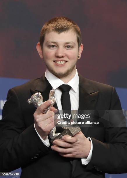 February 2018, Germany, Berlin, Award Ceremony, Berlinale Palace: The French actor Anthony Bajon holds up his silver bear for Best Actor for the film...