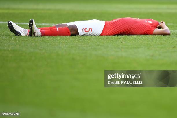 Switzerland's defender Manuel Akanji reacts to Sweden's victory at the end of the the Russia 2018 World Cup round of 16 football match between Sweden...