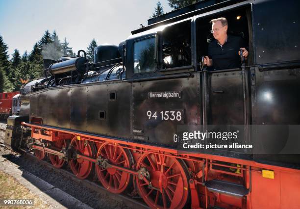 July 2018, Germany, Schmiedefeld: Thuringia Premier Bodo Ramelow riding into Rennsteig Station in the cab of freight train tank engine 941538 of the...