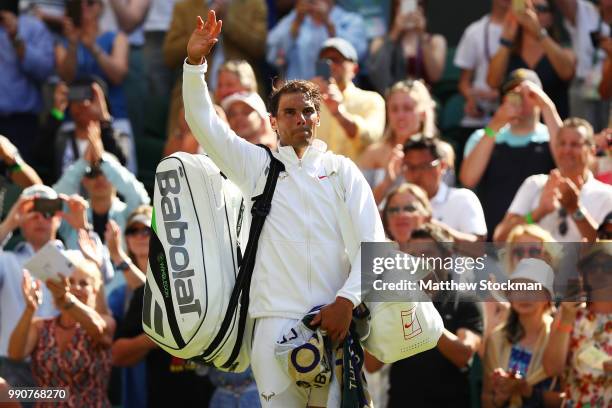 Rafael Nadal of Spain waves to his fans as he leaves Centre Court after winning his Men's Singles first round match against Dudi Sela of Isreal on...