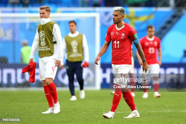 Nico Elvedi and Valon Behrami of Switzerland shows his dejection following the 2018 FIFA World Cup Russia Round of 16 match between Sweden and...