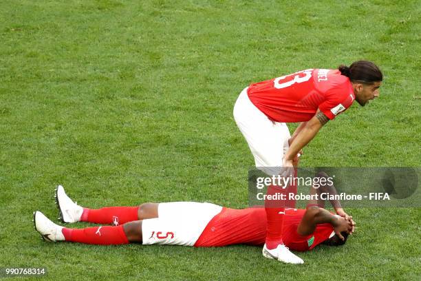 Manuel Akanji and Ricardo Rodriguez of Switzerland look dejected following the 2018 FIFA World Cup Russia Round of 16 match between Sweden and...