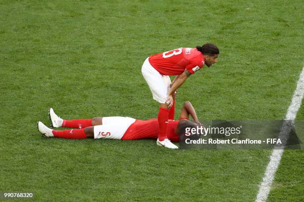 Manuel Akanji and Ricardo Rodriguez of Switzerland look dejected following the 2018 FIFA World Cup Russia Round of 16 match between Sweden and...