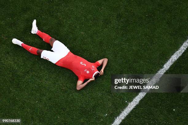 Switzerland's defender Manuel Akanji reacts at the end of the Russia 2018 World Cup round of 16 football match between Sweden and Switzerland at the...