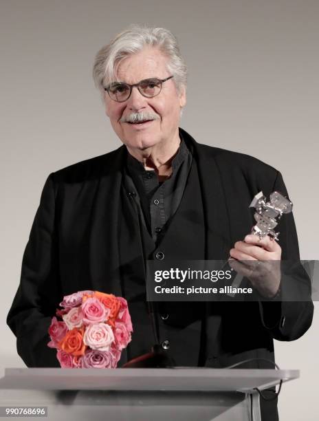 Actor Peter Simonischek speaks after receiving the "Berlinale Camera" award on behalf of Czech director Jiri Menzel during the 68th Berlinale...