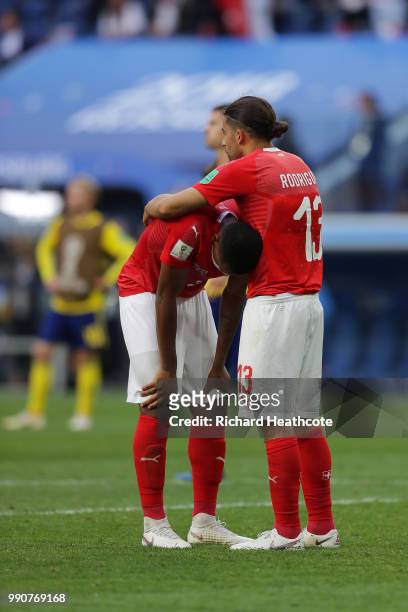 Ricardo Rodriguez of Switzerland consoles team mate Manuel Akanji following the 2018 FIFA World Cup Russia Round of 16 match between Sweden and...