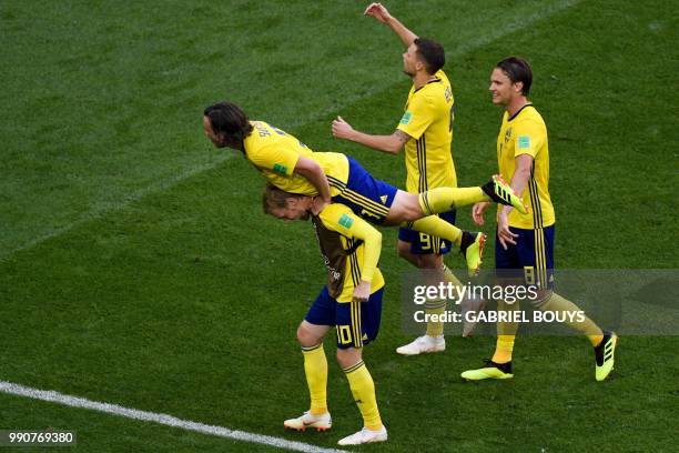 Sweden's midfielder Emil Forsberg celebrates with teammates Sweden's midfielder Gustav Svensson , Sweden's forward Marcus Berg and Sweden's...