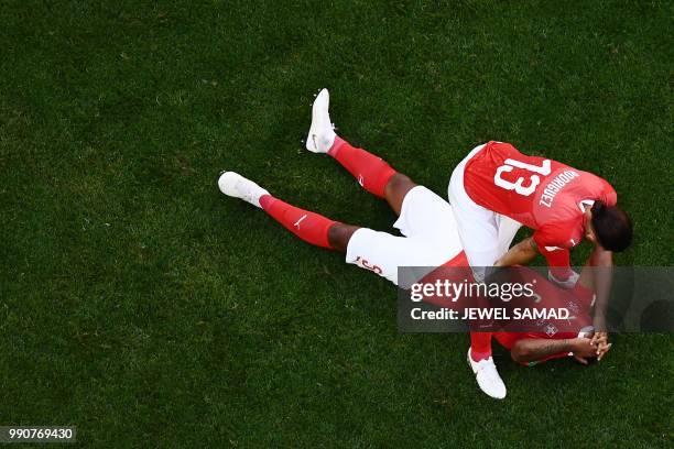 Switzerland's defender Manuel Akanji and Switzerland's defender Ricardo Rodriguez react at the end of the Russia 2018 World Cup round of 16 football...