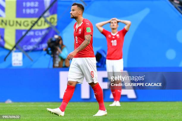 Switzerland's forward Haris Seferovic and midfielder Granit Xhaka react after losing the Russia 2018 World Cup round of 16 football match between...