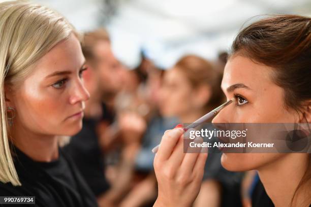 Model prepares backstage ahead of the Lena Hoschek show during the Berlin Fashion Week Spring/Summer 2019 at ewerk on July 3, 2018 in Berlin, Germany.