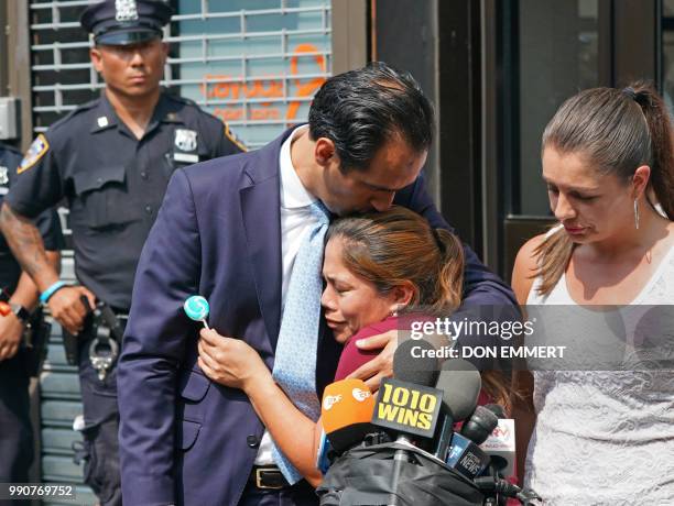 Yeni Marciela Gonzalez Garcia, of Guatemala, the mother of three children at the Cayuga House in Harlem,receives a hug as she speaks at a news...