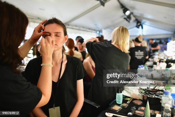 Model prepares backstage ahead of the Lena Hoschek show during the Berlin Fashion Week Spring/Summer 2019 at ewerk on July 3, 2018 in Berlin, Germany.