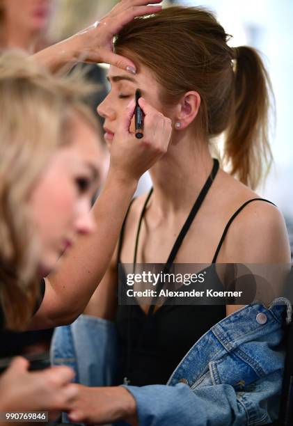 Model prepares backstage ahead of the Lena Hoschek show during the Berlin Fashion Week Spring/Summer 2019 at ewerk on July 3, 2018 in Berlin, Germany.