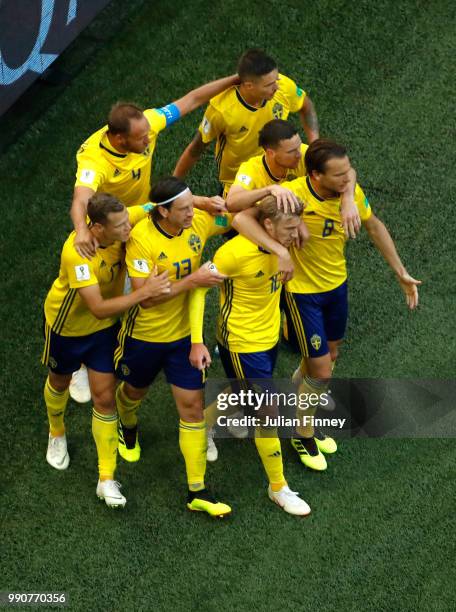 Emil Forsberg of Sweden celebrates with teammates after scoring his team's first goal during the 2018 FIFA World Cup Russia Round of 16 match between...