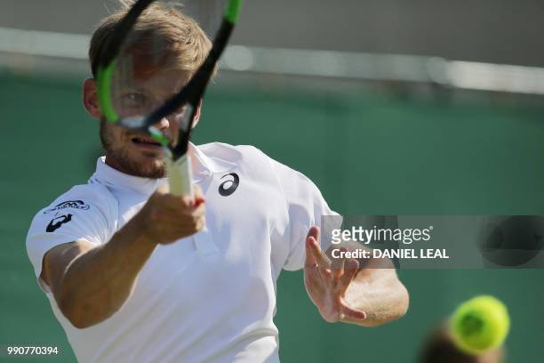 Belgium's David Goffin returns to Australia's Matthew Ebden during their men's singles first round match on the second day of the 2018 Wimbledon...