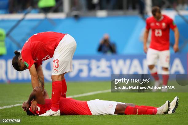 Manuel Akanji of Switzerland is consoled by Ricardo Rodriguez of Switzerland at the end of the 2018 FIFA World Cup Russia Round of 16 match between...