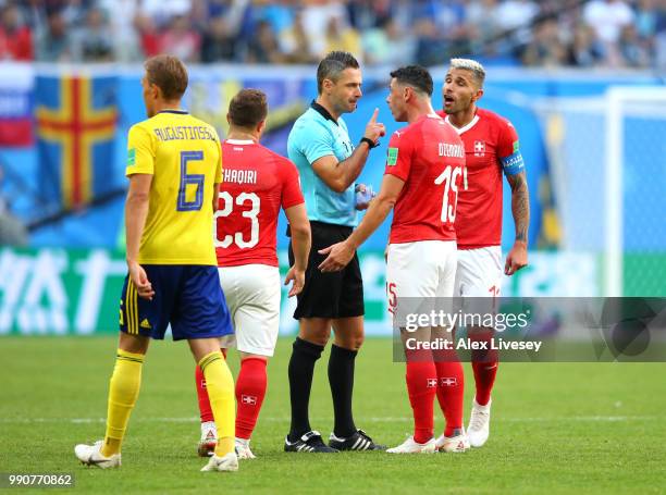 Referee Damir Skomina speaks with Blerim Dzemaili of Switzerland during the 2018 FIFA World Cup Russia Round of 16 match between Sweden and...