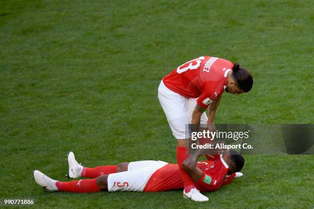 Manuel Akanji#5 of Switzerland is dejected while Ricardo Rodriguez consoles him after the final whistle during the 2018 FIFA World Cup Russia Round...