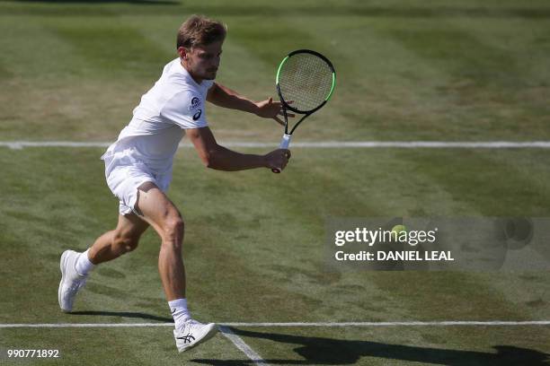 Belgium's David Goffin returns to Australia's Matthew Ebden during their men's singles first round match on the second day of the 2018 Wimbledon...