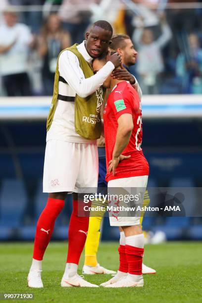 Xherdan Shaqiri of Switzerland is consoled by Deni Zakaria of Switzerland at the end of the 2018 FIFA World Cup Russia Round of 16 match between...