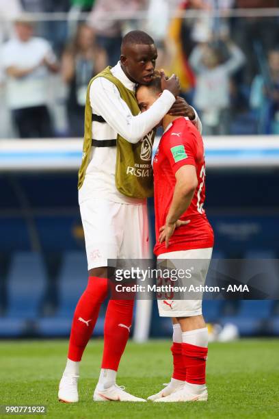 Xherdan Shaqiri of Switzerland is consoled by Deni Zakaria of Switzerland at the end of the 2018 FIFA World Cup Russia Round of 16 match between...