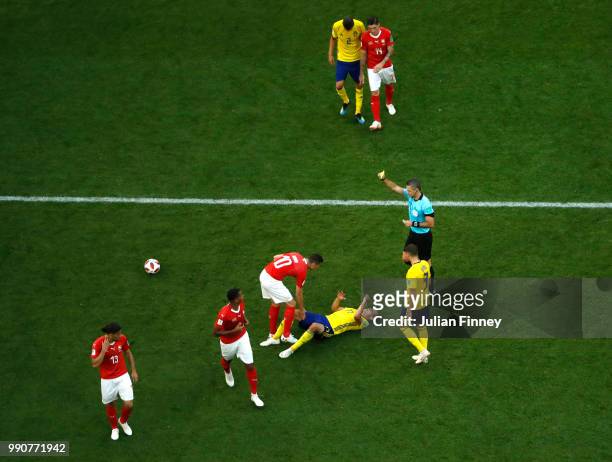 Referee Damir Skomina shows Granit Xhaka of Switzerland a yellow card during the 2018 FIFA World Cup Russia Round of 16 match between Sweden and...