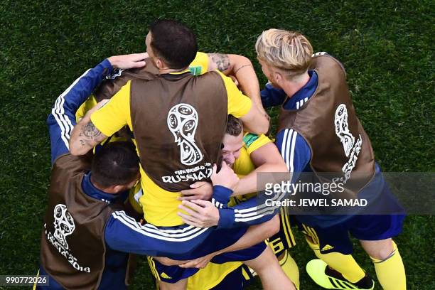 Sweden's players celebrate at the end of the Russia 2018 World Cup round of 16 football match between Sweden and Switzerland at the Saint Petersburg...