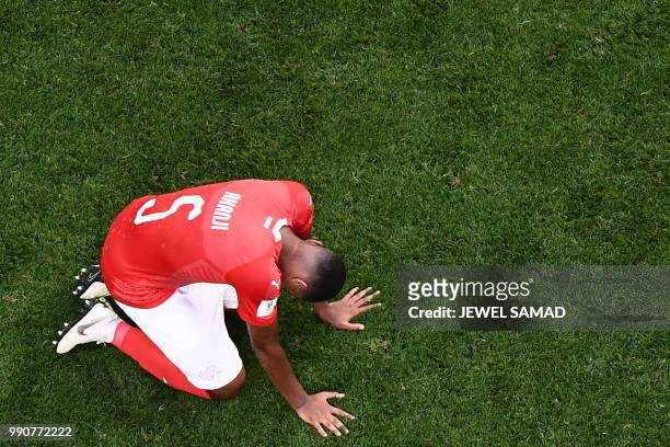 Switzerland's defender Manuel Akanji looks dejected at the end of the Russia 2018 World Cup round of 16 football match between Sweden and Switzerland...