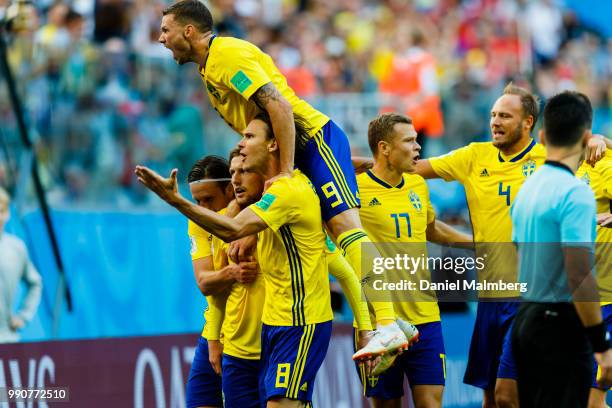 Emil Forsberg of Sweden celebrates scoring goal 1-0, the result of the game, together with his teammates during the 2018 FIFA World Cup Russia Round...