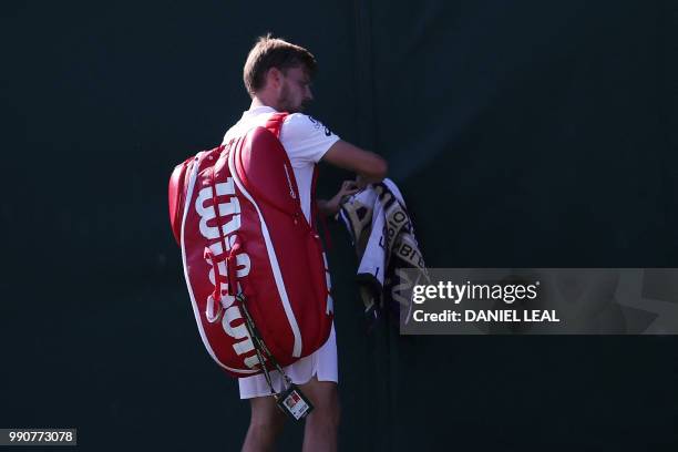 Belgium's David Goffin tries to leave court 3 after losing to Australia's Matthew Ebden during their men's singles first round match on the second...