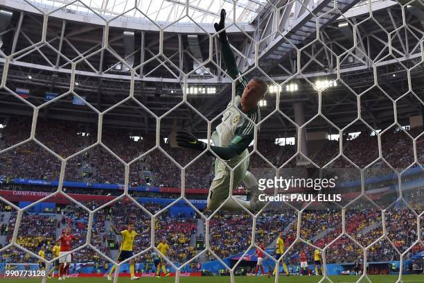 Sweden's goalkeeper Robin Olsen dives during the Russia 2018 World Cup round of 16 football match between Sweden and Switzerland at the Saint...