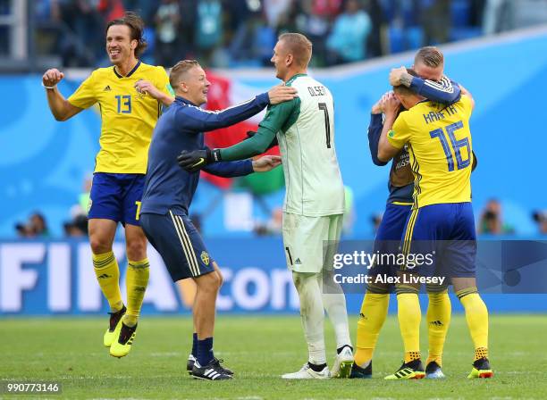 Gustav Svensson, Karl-Johan Johnsson, Robin Olsen and Emil Krafth of Sweden celebrate victory following the 2018 FIFA World Cup Russia Round of 16...