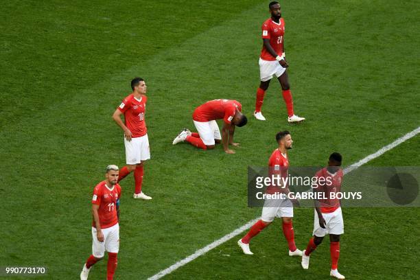 Switzerland's players look dejected at the end of the Russia 2018 World Cup round of 16 football match between Sweden and Switzerland at the Saint...