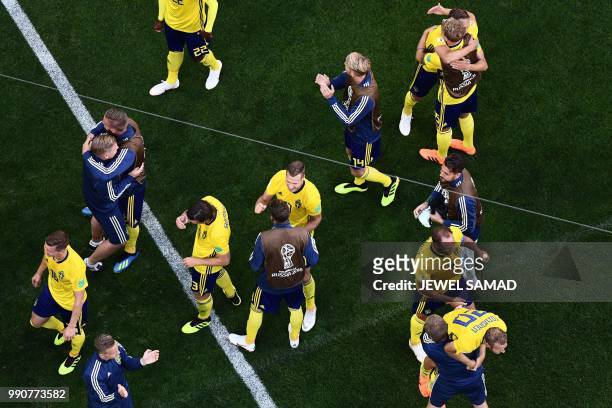 Sweden's players celebrate at the end of the Russia 2018 World Cup round of 16 football match between Sweden and Switzerland at the Saint Petersburg...