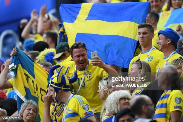 Sweden's fans celebrate their victory at the end of the Russia 2018 World Cup round of 16 football match between Sweden and Switzerland at the Saint...