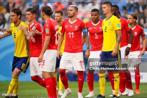 Valon Behrami of Switzerland and Manuel Akanji of Switzerland look on during the 2018 FIFA World Cup Russia Round of 16 match between Sweden and...