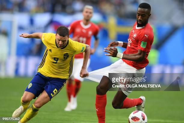 Sweden's forward Marcus Berg pulls the shorts of Switzerland's defender Johan Djourou during the Russia 2018 World Cup round of 16 football match...