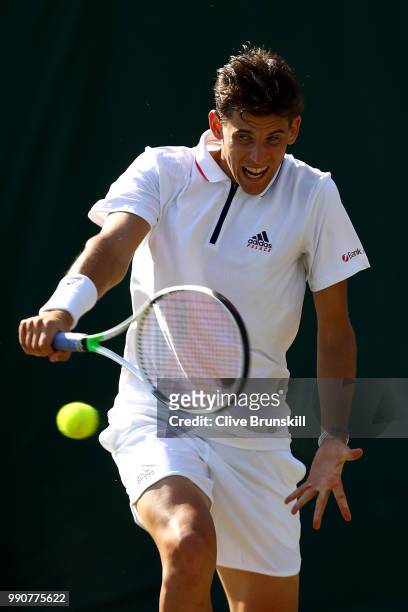 Dominic Thiem of Austria returns against Marcos Baghdatis of Cyprus during their Men's Singles first round match on day two of the Wimbledon Lawn...