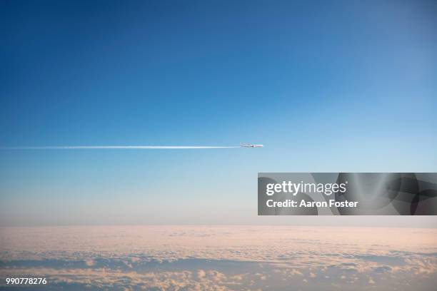 gerneric aircraft in flight with con trail - aircraft planes aaron foster stock pictures, royalty-free photos & images