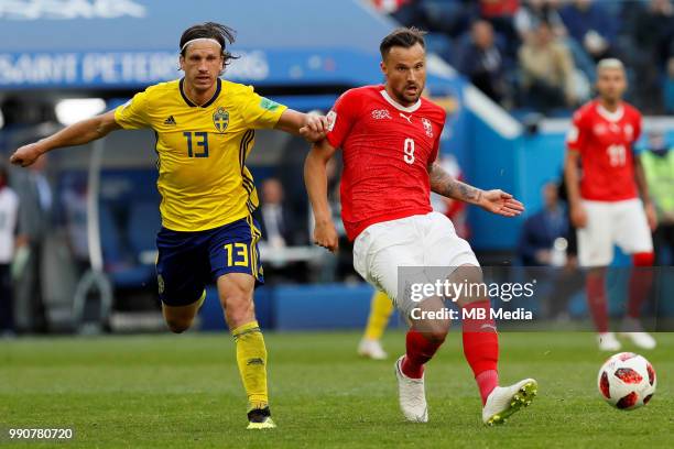 Gustav Svensson of Sweden national team and Haris Seferovic of Switzerland national team vie for the ball during the 2018 FIFA World Cup Russia Round...