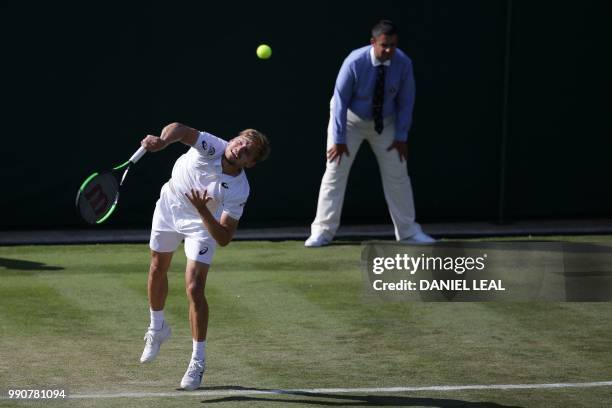 Belgium's David Goffin serves to Australia's Matthew Ebden during their men's singles first round match on the second day of the 2018 Wimbledon...