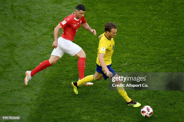 Albin Ekdal of Sweden pursuits Josip Drmic of Switzerland during the 2018 FIFA World Cup Russia Round of 16 match between Sweden and Switzerland at...