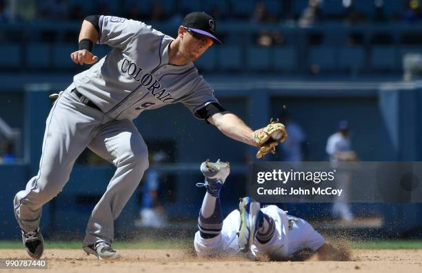 LeMahieu of the Colorado Rockies"n catches Austin Barnes of the Los Angeles Dodgers stealing in the sixth inning at Dodger Stadium on July 1, 2018 in...