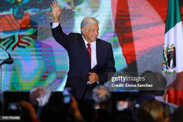 Andres Manuel Lopez Obrador waves before leaving to celebrate after giving a speech for his virtual victory for the presidency of Mexico at his party...